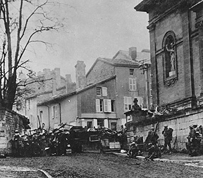 Taken at 10:58 a.m., on Nov. 11, 1918, just before the Armistice went into effect; men of the 353rd Infantry, near a church, at Stenay, Meuse, wait for the end of hostilities. (SC034981)